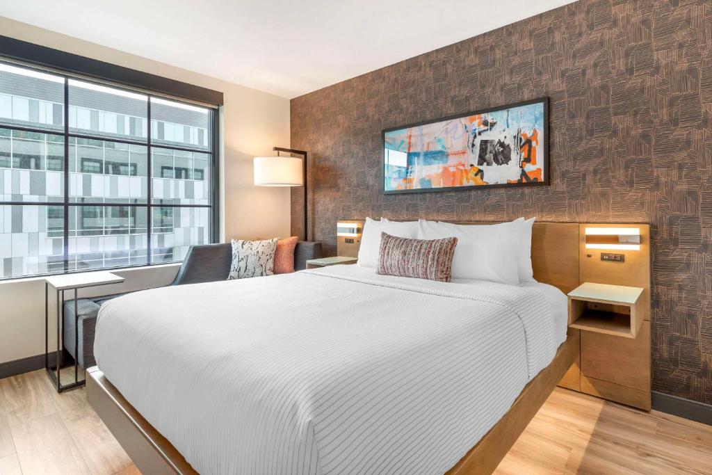 Cambria Hotel Denver Downtown RiNo Bedroom with panoramic window